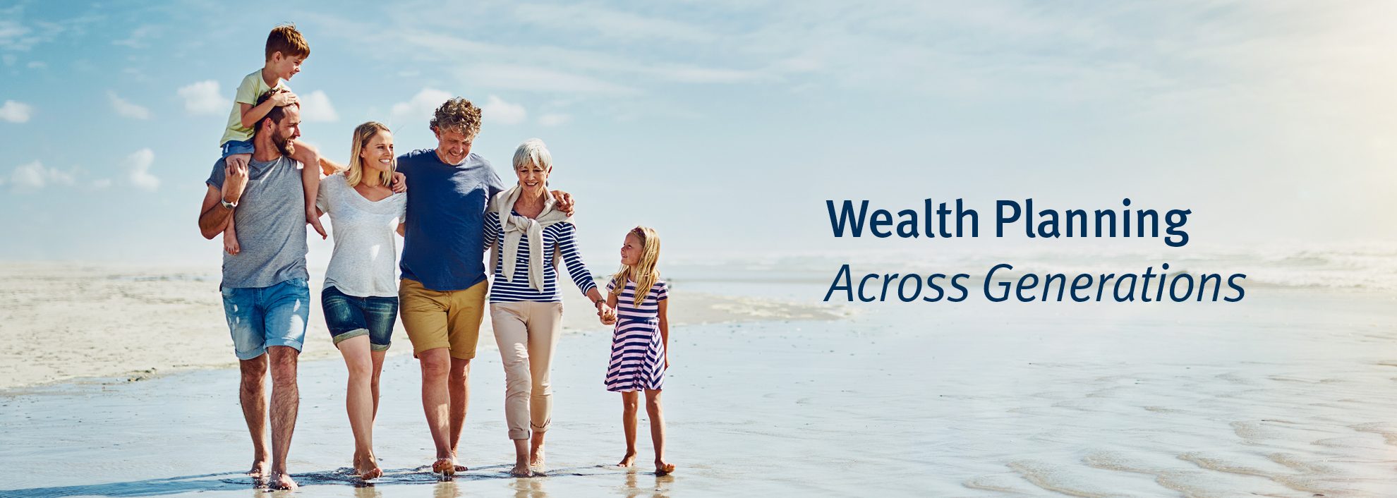 Wealth Planning Across Generations; Image of multi generational family walking down beach